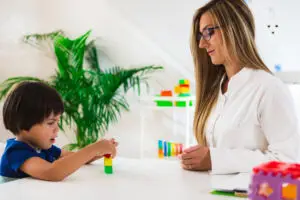 Child psychology, little boy making tower with blocks